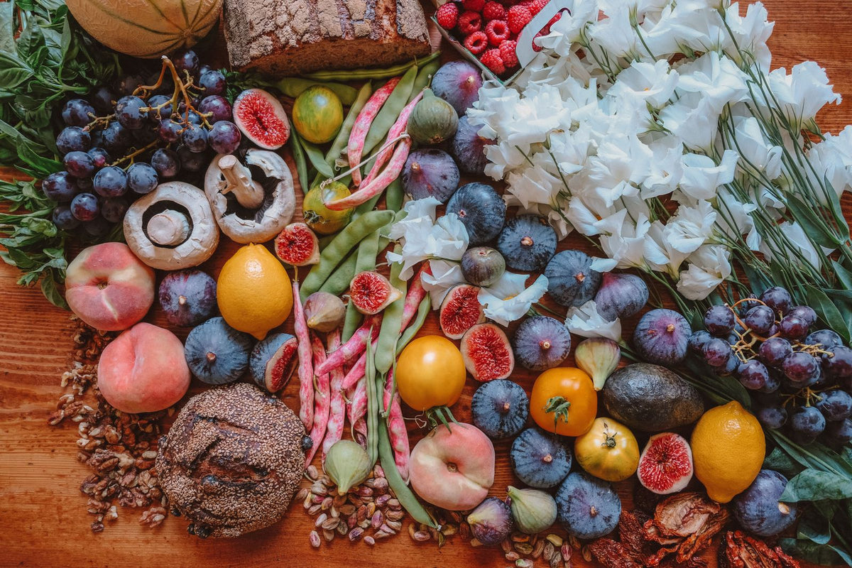 Colorful fresh fruits, vegetables and bread on a wooden table - new arrivals